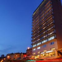 a tall building at night with a street in front of it at Hotel Neboder, Rijeka