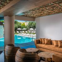 a living room with a couch and chairs and a pool at Anesis Blue Boutique Hotel, Hersonissos