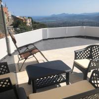 a patio with chairs and tables on a roof at Serraenna Bedrooms, Baunei