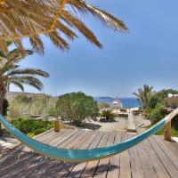 a hammock on a deck with a view of the ocean at Baba Houlakia