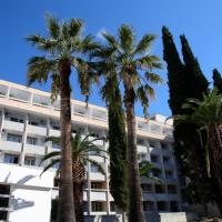 a hotel with palm trees in front of it at Hotel Zagreb, Split