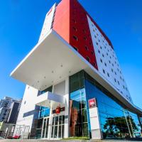 a building with a red cube on top of it at ibis Natal