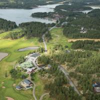 an aerial view of a golf course with a lake at Kultaranta Resort, Naantali
