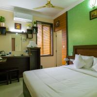 a bedroom with a bed with a green wall at Blue Bell Cochin Airport Hotel, Nedumbassery
