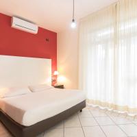 a bedroom with a white bed and a red wall at Hotel La Baia, Bari