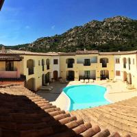 a house with a swimming pool in front of it at Hotel Monti Di Mola, Porto Cervo