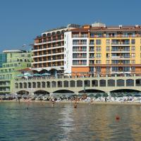 a group of people on a beach in front of a building at Mirage Hotel, Nesebar