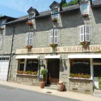 an old stone building with flowers in the windows at Auberge de la Tradition, Corrèze