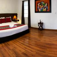 a bedroom with a bed and a wooden floor at Hotel Santiago de Compostella Suites, Cuenca