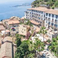 an aerial view of a town on a hill with the ocean at Hotel Ariston and Palazzo Santa Caterina, Taormina