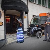 a man and a woman standing next to a scooter at Eight Hotel Portofino