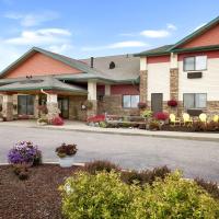 a front view of a hotel with flowers at Super 8 by Wyndham Eveleth