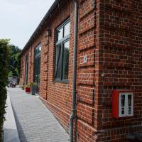 a red brick building with a sidewalk next to it at Bahnhof Vaale • Fliegender Hamburger