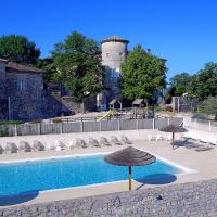 a swimming pool with umbrellas in front of a castle at Château De Chaussy, Ruoms