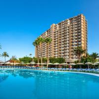 a large swimming pool with umbrellas and a large building at Sol Arona Tenerife, Los Cristianos