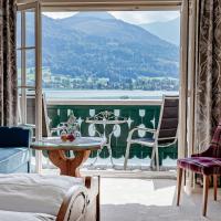 a room with a balcony with a view of the water at Hotel Peter, St. Wolfgang