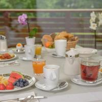 a table topped with plates of breakfast foods and drinks at Hotel dala, Leukerbad
