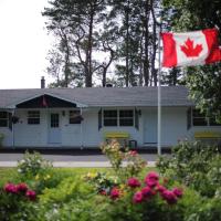 a canadian flag flying in front of a house at CARLETON INN & COTTAGES, Bridgetown