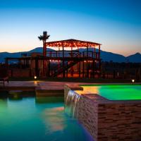 a large swimming pool with a playground in the evening at Cuatro Lunas Hotel Boutique, Valle de Guadalupe