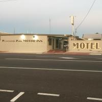 a building with a motel sign on the side of a street at Plantation Park Motor Inn, Ayr