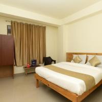 a bedroom with a large bed and a podium in it at Hotel Travellers INN, Shillong