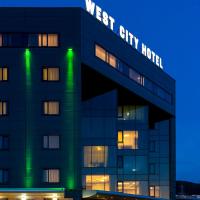 a building with the words west city hotel at night at West City Hotel, Cluj-Napoca