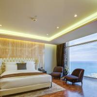 a bedroom with a large bed and a large window at Lancaster Plaza Beirut