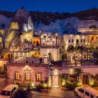 a building with cars parked in a parking lot at night at Artemis Cave Suites & Spa- Adults Only, Göreme