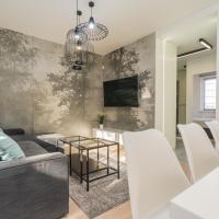 a living room with a couch and a table at Apartamenty Premium Wadowice