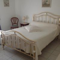 a bedroom with a bed with a white bedspread at Maison Tobias, Bussy-Saint-Georges