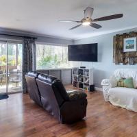 a living room with a white couch and a ceiling fan at Sandpiper #105a, Princeville