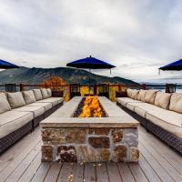 a patio with couches and a fire pit on a deck at Grand Lake Lodge