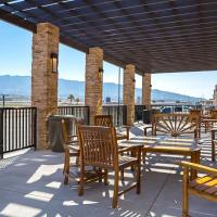 a patio with tables and chairs on a balcony at The Hotel at Sunland Park Casino El Paso, Ascend Hotel Collection