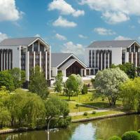 a rendering of a campus with a river and buildings at Beijing Hotel Minsk