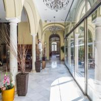 a large building with glass windows and a lobby at Hotel Palacio Garvey, Jerez de la Frontera