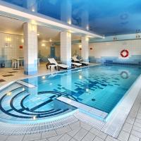a large swimming pool in a building at Hotel Festival, Opole