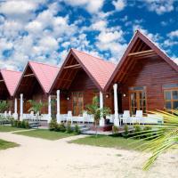 a house with a red roof on a beach at Elegant Green Beach Resort, Trincomalee