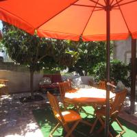 a table with an orange umbrella on a patio at Casas Botelho Elias, Pinhão