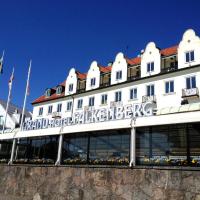 a large white building with a sign on it at Grand Hotel Falkenberg