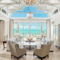 a living room with a couch and chairs and a table at The Shore Club Turks & Caicos, Grace Bay