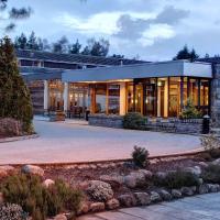 a house with a patio and a building at Coylumbridge Hotel, Aviemore