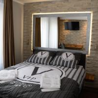 a bedroom with a bed with pillows and a mirror at Villa Vip, Gniezno
