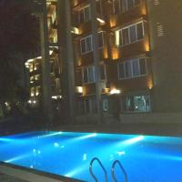 a swimming pool in front of a building at night at Sinclairs Bayview, Port Blair