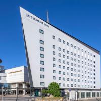 a large white building with a sign on it at JR Clement Inn Takamatsu