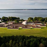an aerial view of a building with the water in the background at Konventum Conference Center, Helsingør