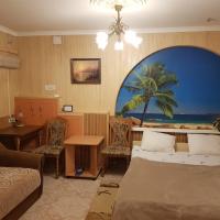 a hotel room with a bed and a table and chairs at Elena, Kherson
