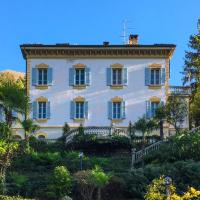 a large white house on a hill with trees at B&B Villa Costanza, Blevio