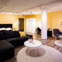 a living room with a couch and a table at Hotel Vanha Rauma