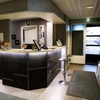an office with a counter with a mirror and a stool at Hotel CityHovi, Rauma