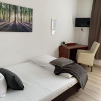 a bedroom with a bed and a desk and a chair at Hotel zum Adler, Bad Homburg vor der Höhe